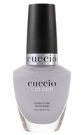 Cuccio Colour I Wonder Where nail polish bottle, vibrant pink shade, with sleek black cap, displayed against white background.