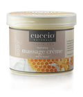 Creamy Cuccio Naturalé Milk & Honey Massage Creme for relaxation, shown in a spa setting with smooth application.
