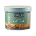 Cuccio Naturalé Scentual Salt Soak with artisan shea and vetiver, shown in a clear container with salt crystals and natural ingredients.