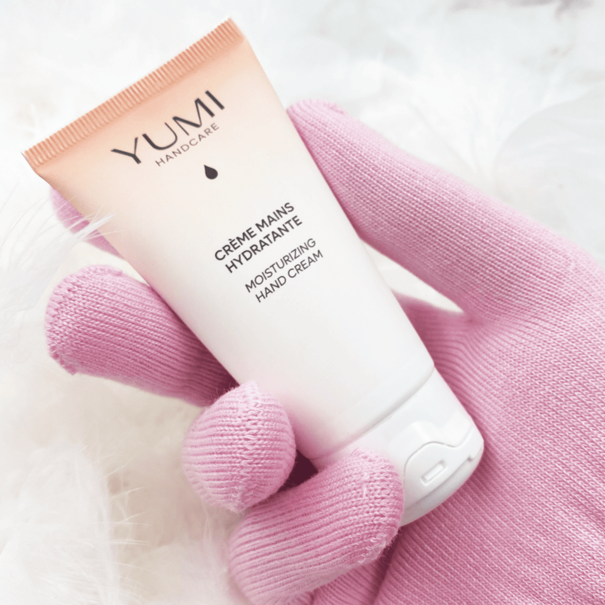 Yumi Handcare Moisturizing Hand Cream tube with white and pink packaging, designed for soft, hydrated hands.