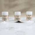 Yumi Skincare Sensicare Facial Cleansing Powder in a white jar, showing the skin care powder used for gentle facial cleansing.