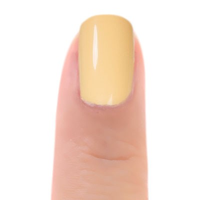 Close-up of Zoya Bee nail polish bottle with shiny yellow cap and clear glass showing vibrant yellow nail polish inside.