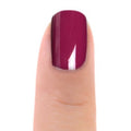 Zoya Donnie nail polish bottle with deep purple shade, featuring a sleek black cap and clear Zoya branding on the label.
