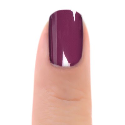 Close-up of Zoya Kendra nail polish bottle, showcasing the sleek design and vibrant nail polish color in a natural setting.