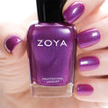 Close-up of Zoya Millie nail polish bottle, showcasing the sleek design and vibrant nail polish color.