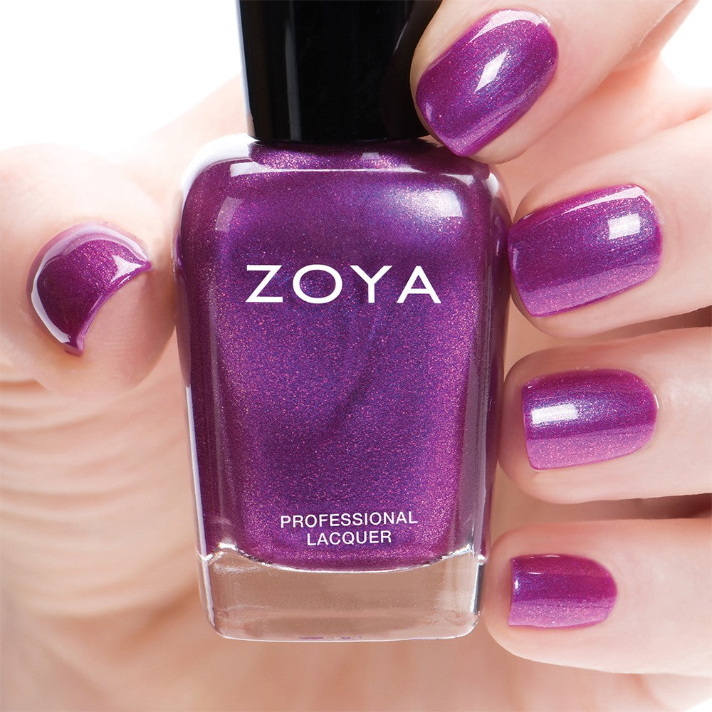 Close-up of Zoya Millie nail polish bottle, showcasing the sleek design and vibrant nail polish color.