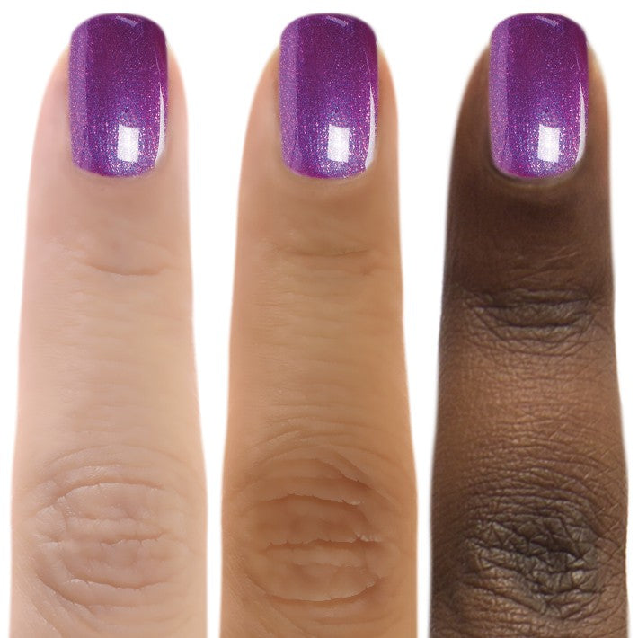 Close-up of Zoya Millie nail polish bottle with the polish swatched on a nail, showcasing the vibrant color and sleek design.