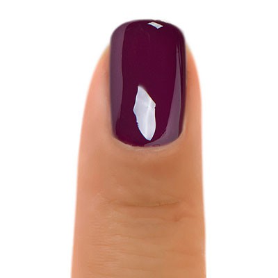 Zoya Tara nail polish bottle with vibrant coral-orange shade, featuring sleek branding and smooth finish.